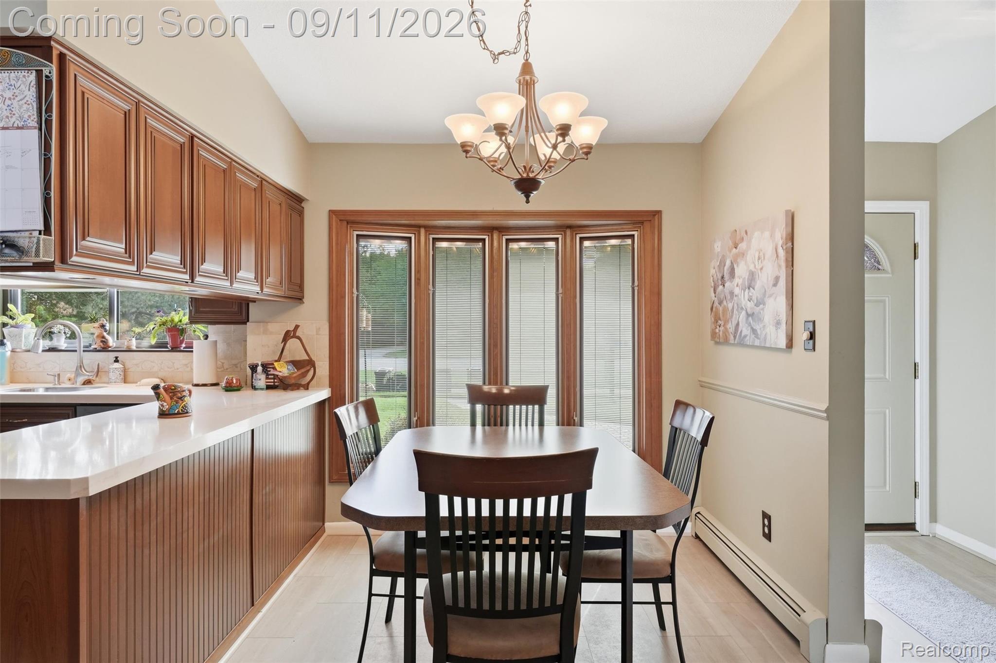 16799 Farmington Road Livonia, MI 48154 - Photo 9 of 71 Kitchen with wood-finish cabinetry, light-toned countertops, and a bay window