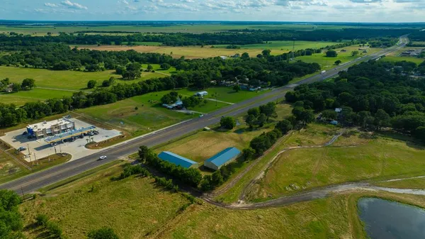 an aerial view of a residential houses with outdoor space and swimming pool