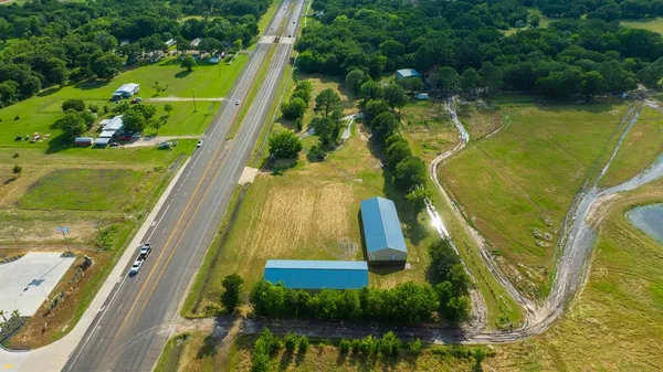 an aerial view of a residential houses with outdoor space and street view