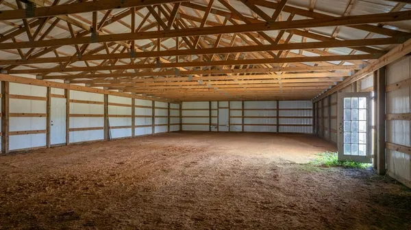 a view of an empty room with a wooden floor and a window