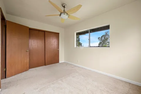 a view of room with window and ceiling fan