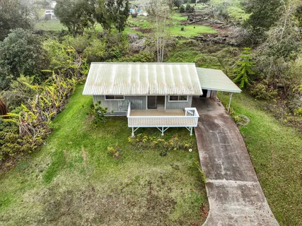 a view of a backyard with a garden and deck