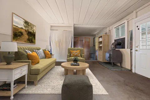 a living room with furniture and a chandelier