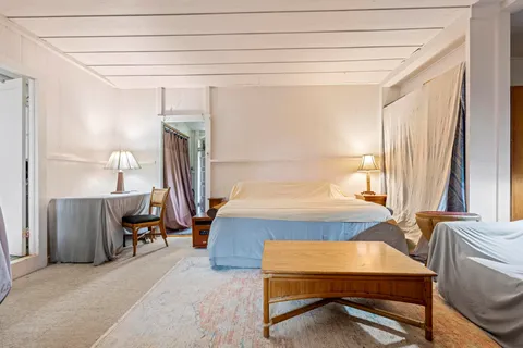 a bedroom with furniture and a window