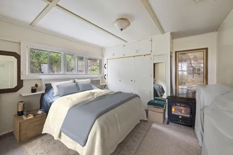 a bed room with a bed and a window