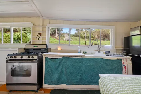 a kitchen with a stove a sink and a microwave