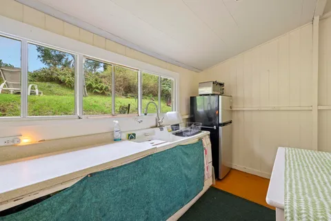a kitchen with a sink a refrigerator and a large window