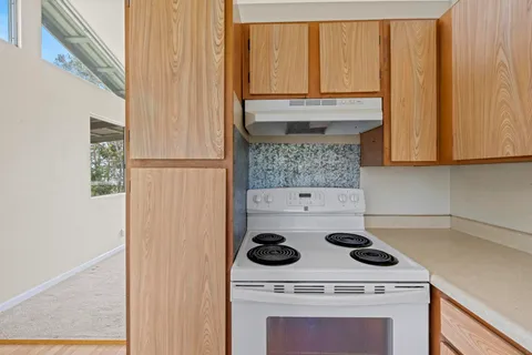 a kitchen with a stove and a microwave