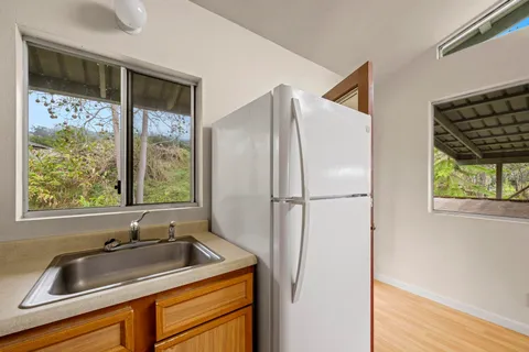 a view of a sink cabinets and a window