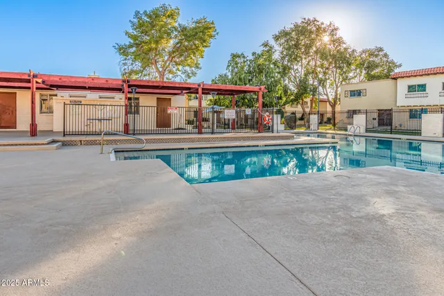 front view of a house with a garden and swimming pool