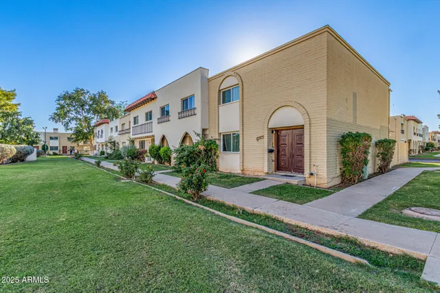 a front view of a house with a garden