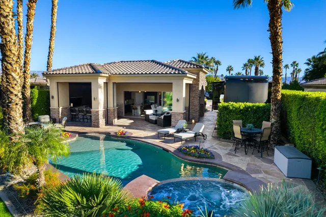 a view of a house with swimming pool patio and a garden