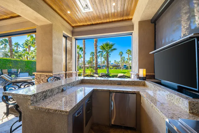 a living room with fireplace furniture and a large window