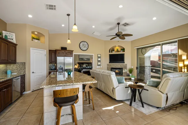 a living room with furniture kitchen view and a fireplace