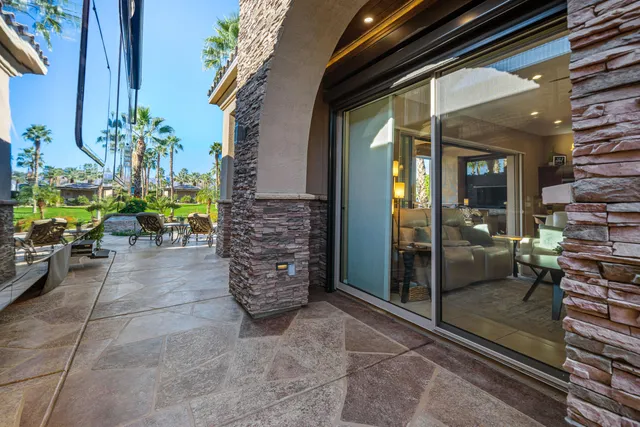 a living room with furniture a fireplace and a large window