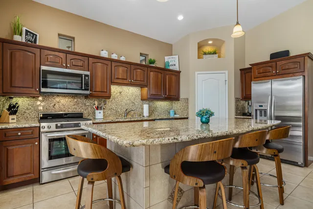 a kitchen with a stove sink and refrigerator