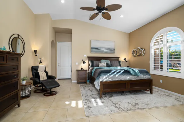 a bathroom with a granite countertop sink a toilet and a shower