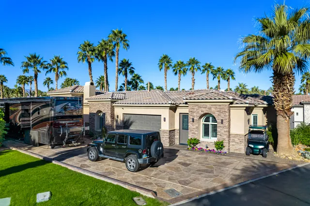 a view of a backyard with a patio and a garden