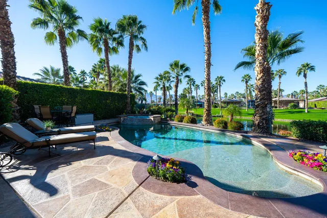 a view of a house with backyard patio and swimming pool