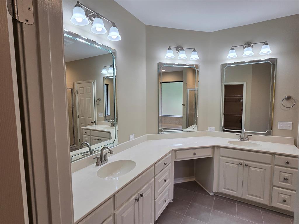 10407 Bethany State Line Road Bethany, LA 71007 - Photo 13 of 19 a bathroom with a double vanity sink and a mirror