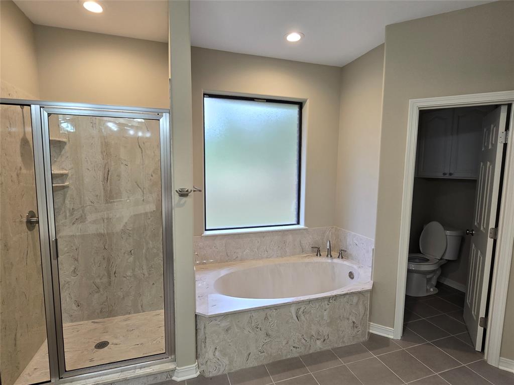 10407 Bethany State Line Road Bethany, LA 71007 - Photo 15 of 19 a bathroom with a bathtub and a shower