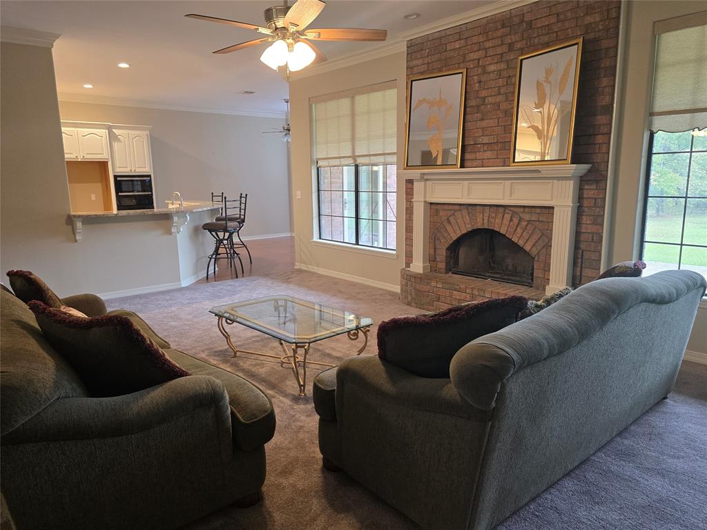 10407 Bethany State Line Road Bethany, LA 71007 - Photo 3 of 19 a living room with furniture a window and a fireplace