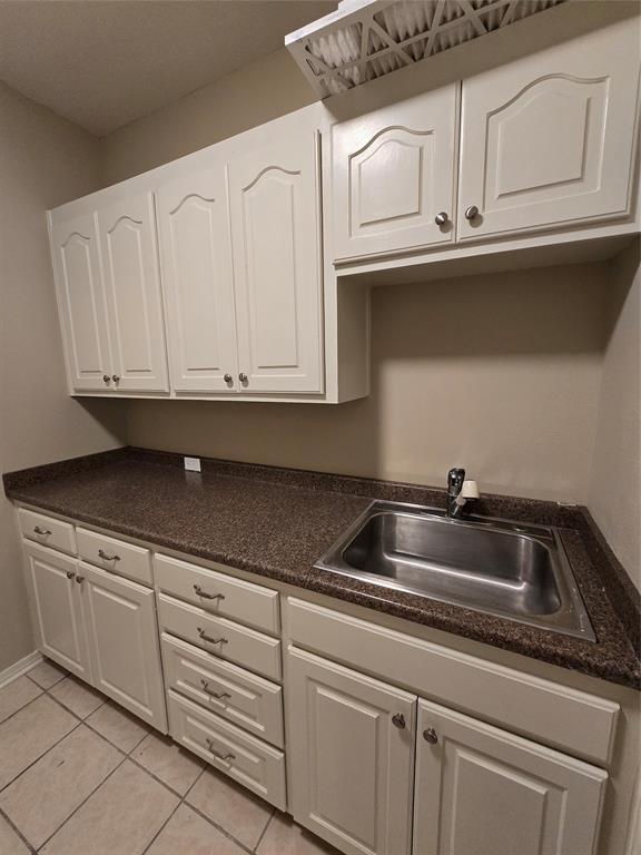 10407 Bethany State Line Road Bethany, LA 71007 - Photo 10 of 19 a kitchen with white cabinets a sink and dishwasher
