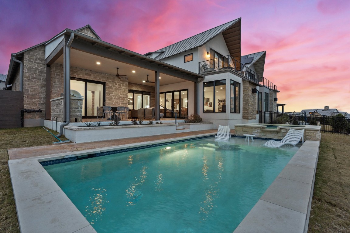 a view of a house with swimming pool and sitting area