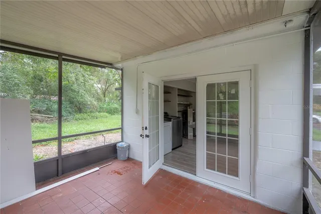 a view of a porch with furniture and garden
