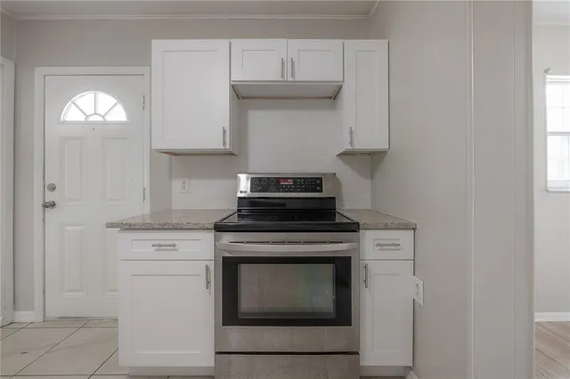 a stove top oven sitting inside of a kitchen