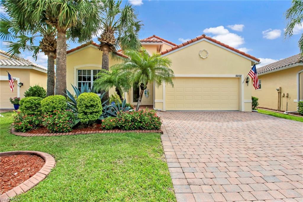 9258 Springview Loop Estero, FL 33928 - Photo 1 of 35 a front view of a house with a yard and garage