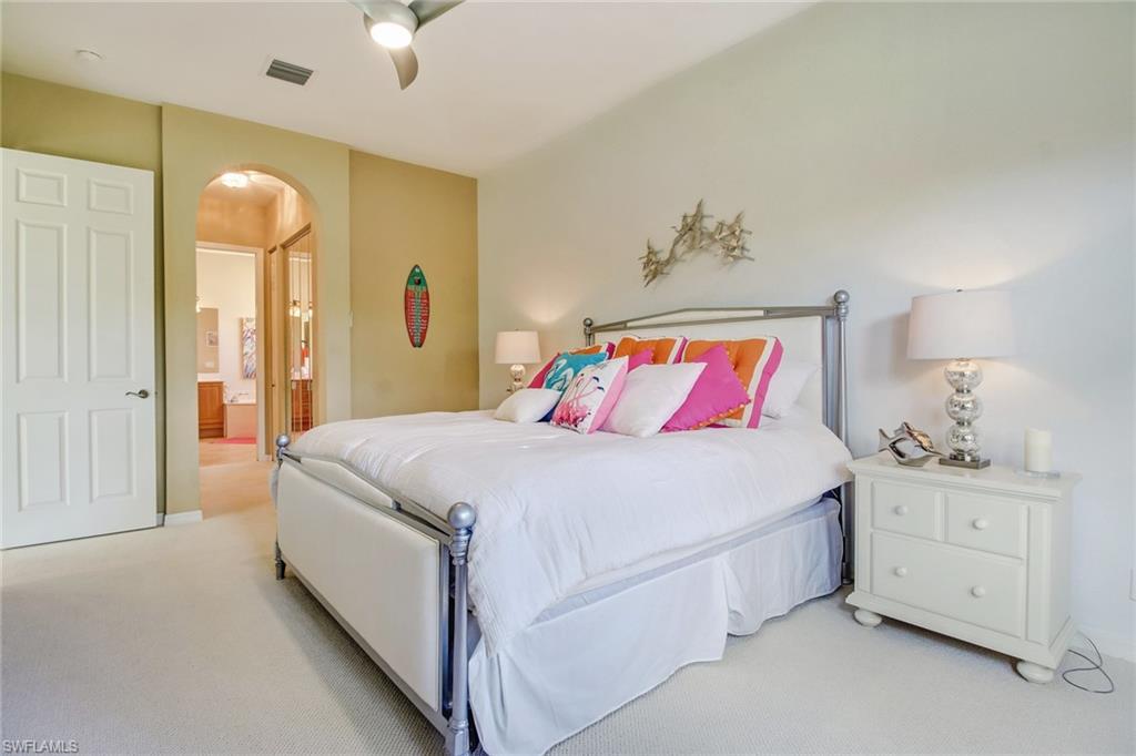 9258 Springview Loop Estero, FL 33928 - Photo 11 of 35 a bedroom with a bed and a chandelier