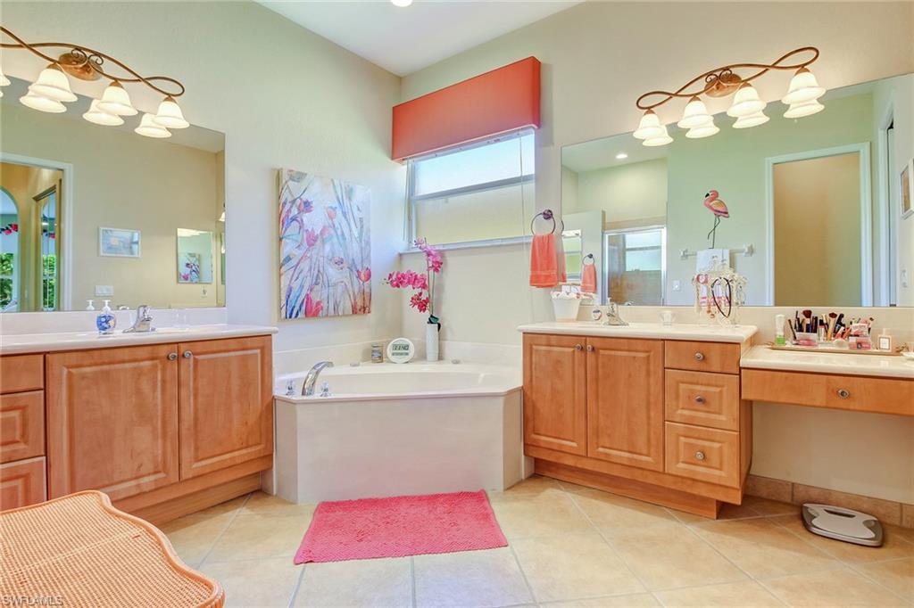 9258 Springview Loop Estero, FL 33928 - Photo 12 of 35 a spacious bathroom with a sink vanity and mirror
