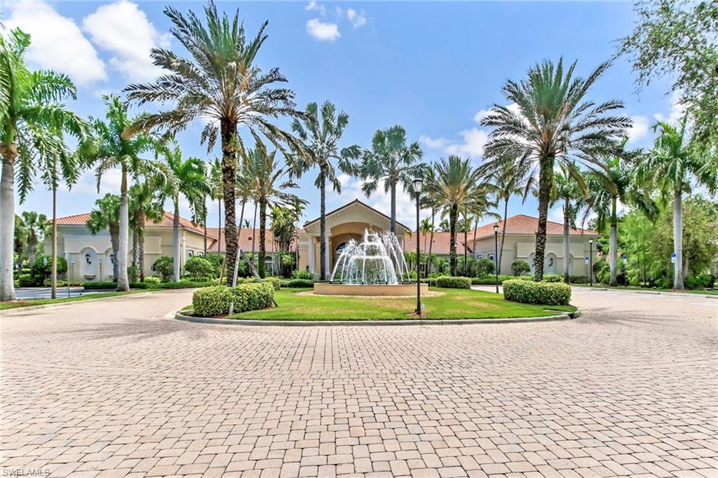 9258 Springview Loop Estero, FL 33928 - Photo 23 of 35 a front view of a house with a yard and palm trees