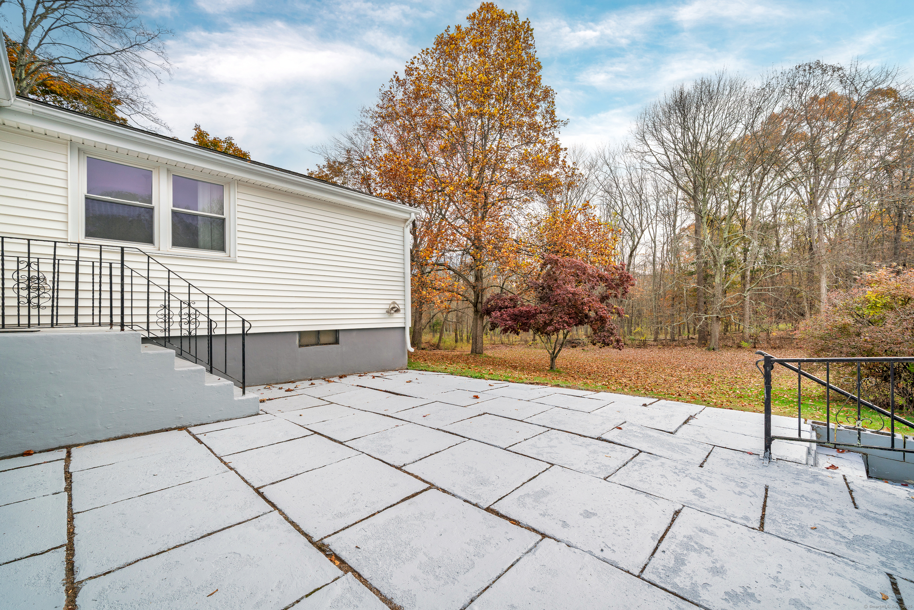 110 Coles Road Cromwell, CT 06416 - Photo 36 of 40 a backyard of a house with large trees and wooden fence