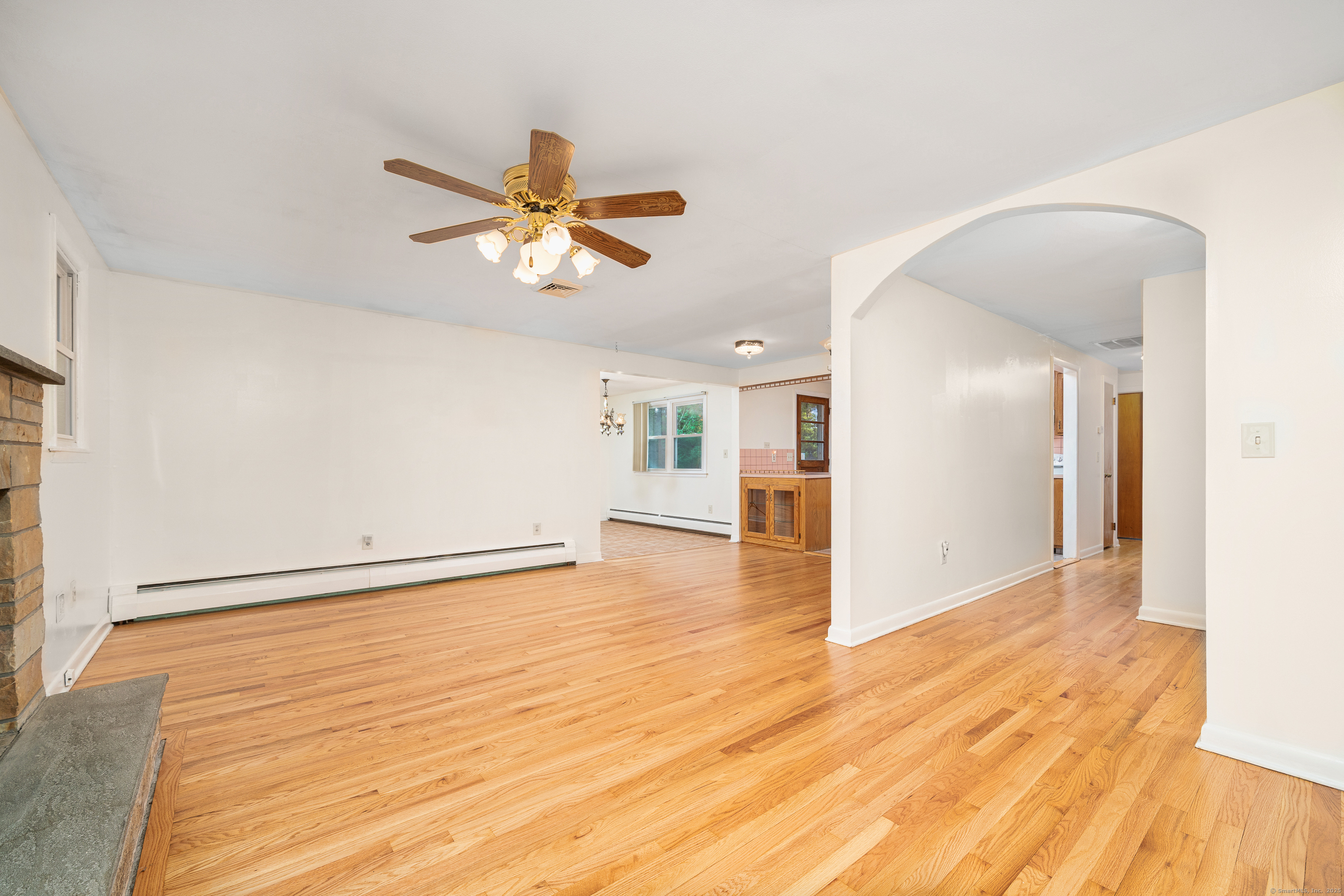 110 Coles Road Cromwell, CT 06416 - Photo 8 of 40 a view of a room with wooden floor and a ceiling fan