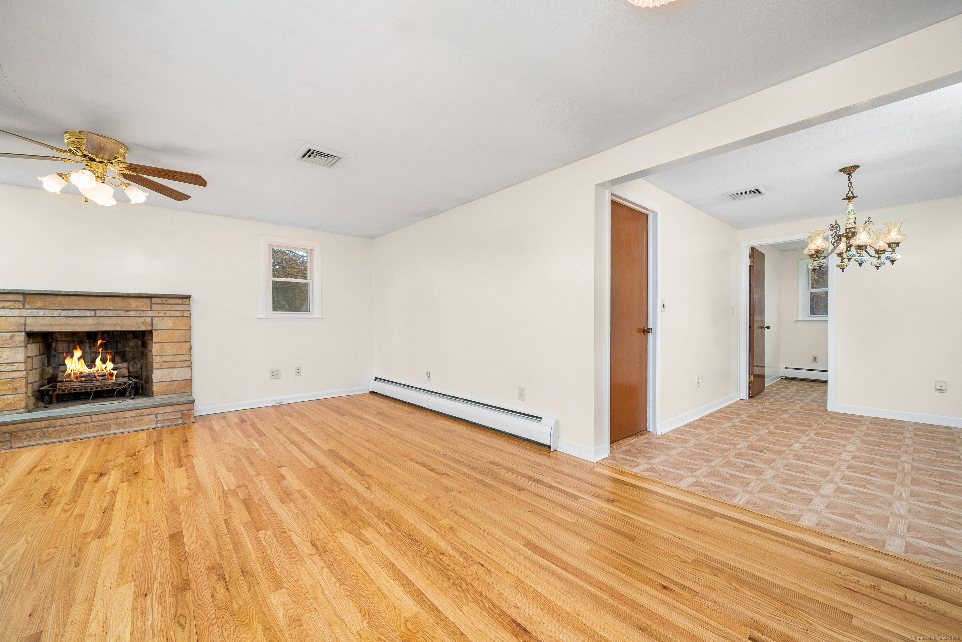 110 Coles Road Cromwell, CT 06416 - Photo 9 of 40 a view of empty room with wooden floor and fireplace
