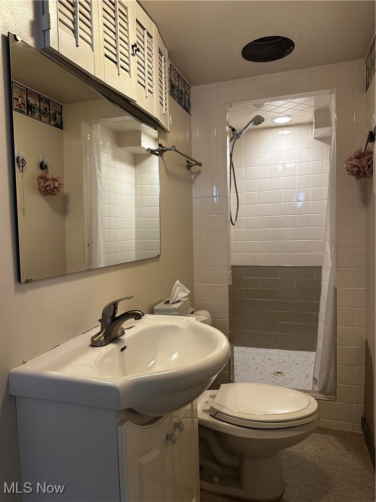 739 Sterling Road Wickliffe, OH 44092 - Photo 22 of 27 Bathroom with walk in shower, toilet, vanity, and tile patterned floors
