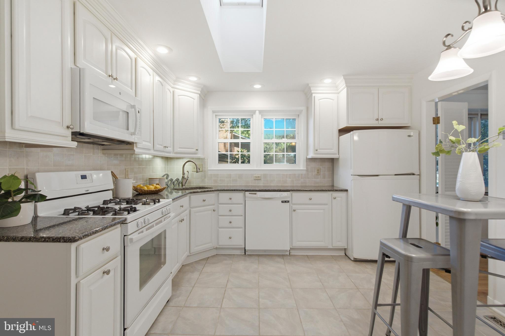 220 Solway Road Lutherville-Timonium, MD 21093 - Photo 9 of 38 a kitchen with cabinets appliances a sink and a counter top space