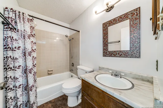 a bathroom with a white toilet a sink and a bathtub