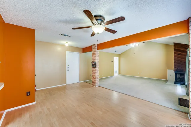 a view of a livingroom with a ceiling fan and window