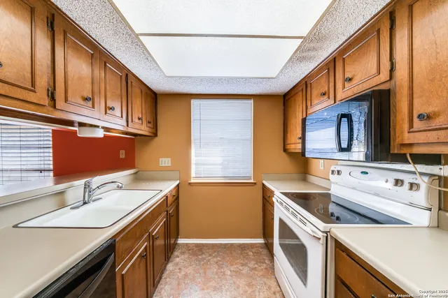 a kitchen that has a sink and a stove