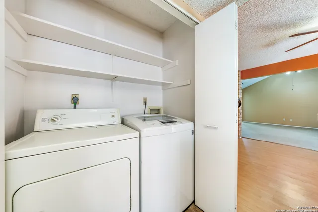 a view of storage and utility room with washer and dryer