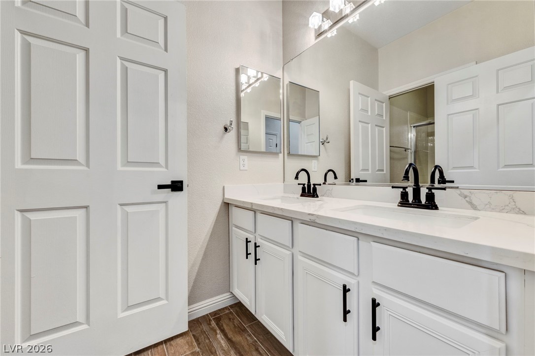 740 Aldo Rae Court, Unit NONE Henderson, NV 89052 - Photo 27 of 35 A well-appointed bath features a double vanity and sleek modern fixtures.