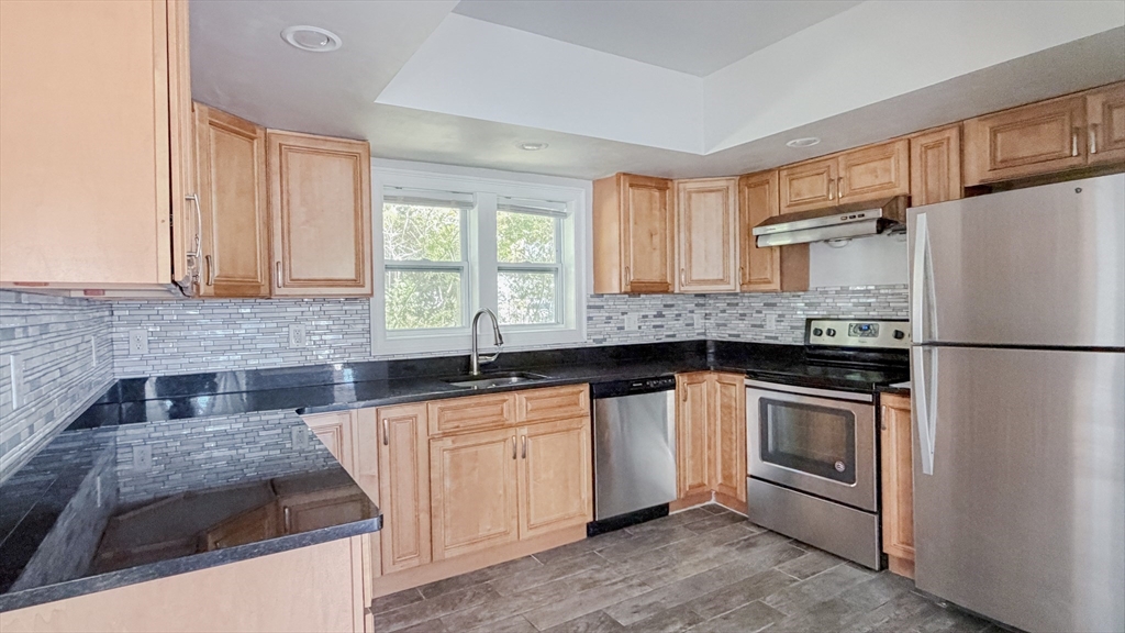 4 Longfellow Road Worcester, MA 01602 - Photo 13 of 36 a kitchen with granite countertop a sink stainless steel appliances and cabinets