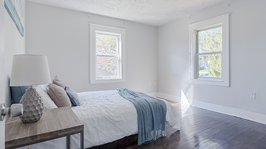 4 Longfellow Road Worcester, MA 01602 - Photo 21 of 36 a bedroom with a bed and wooden floor
