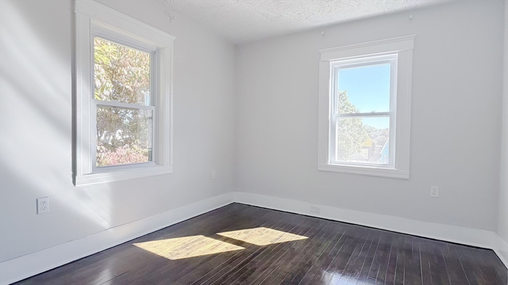 4 Longfellow Road Worcester, MA 01602 - Photo 24 of 36 an empty room with wooden floor and windows