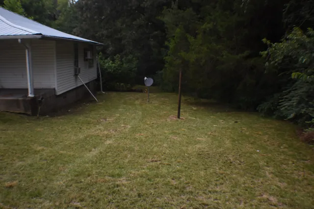 a backyard of a house with lots of green space