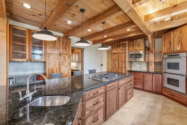 a kitchen with stainless steel appliances granite countertop a sink stove and cabinets
