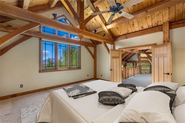 a bedroom with a large bed and a large window